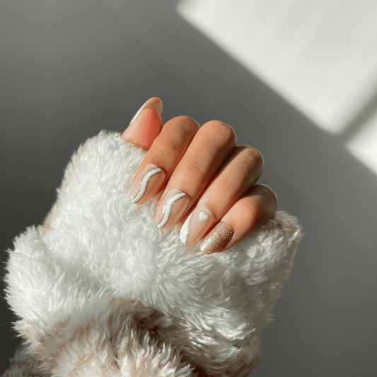 Stylish CLARA press-on nails featuring nude base and glitter.