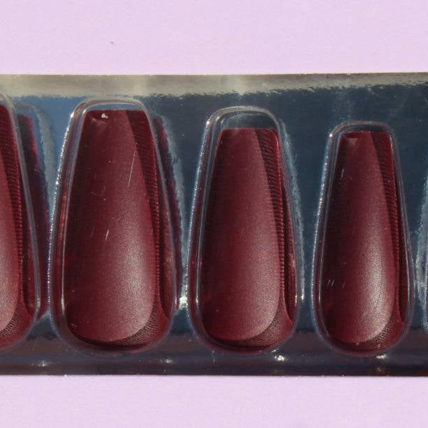 Set of burgundy press-on nails in packaging