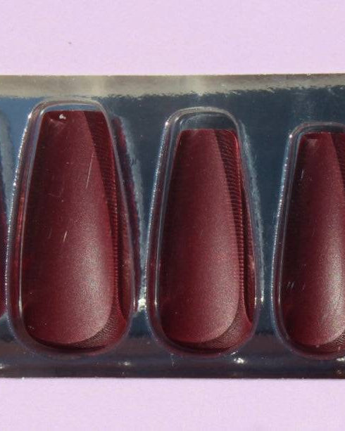 Set of burgundy press-on nails in packaging