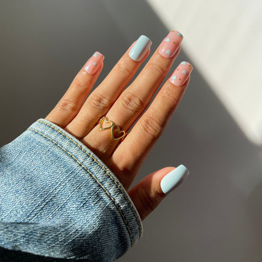 Chic square Mila press-on nails with heart accents.