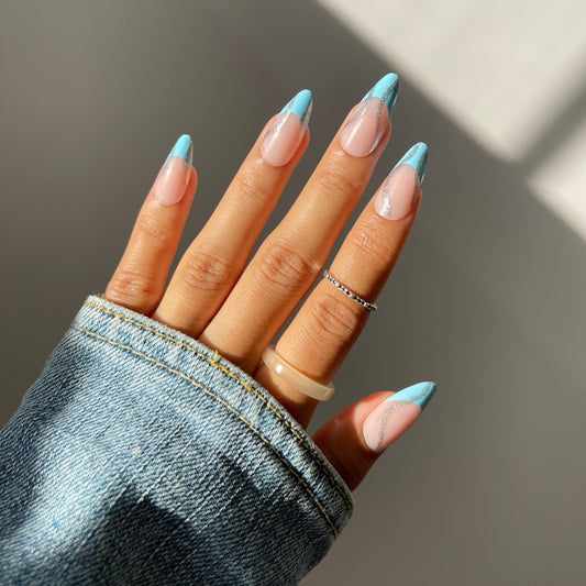Sky blue almond press-on nails on hand