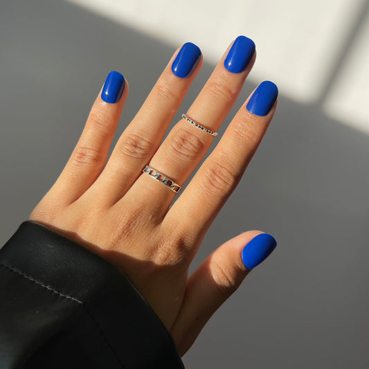 Indigo press-on nails on hand with rings