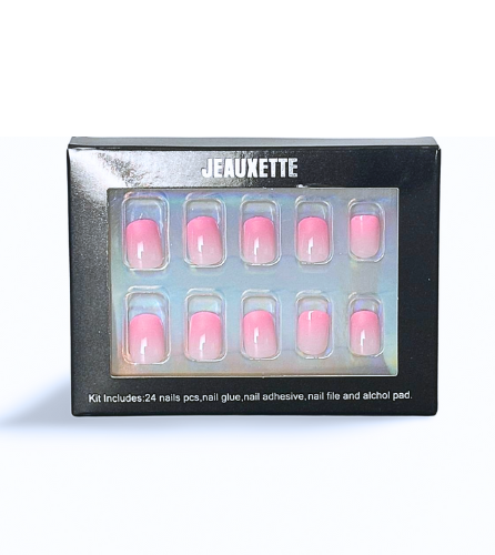 Gradient pink shoer square press-on nails in a black box against black background