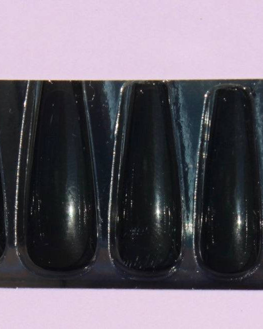 Close-up of glossy black press-on nails set