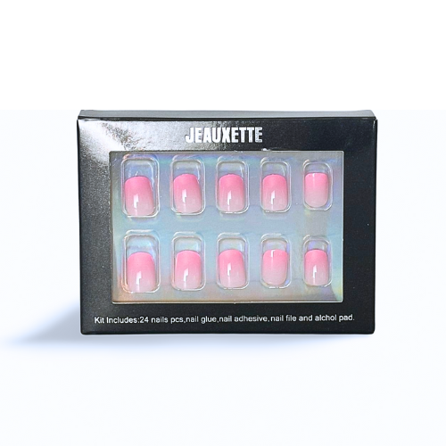 Gradient pink shoer square press-on nails in a black box against black background