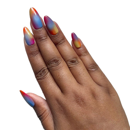 Hand with multicolored press-on nails on a gray background