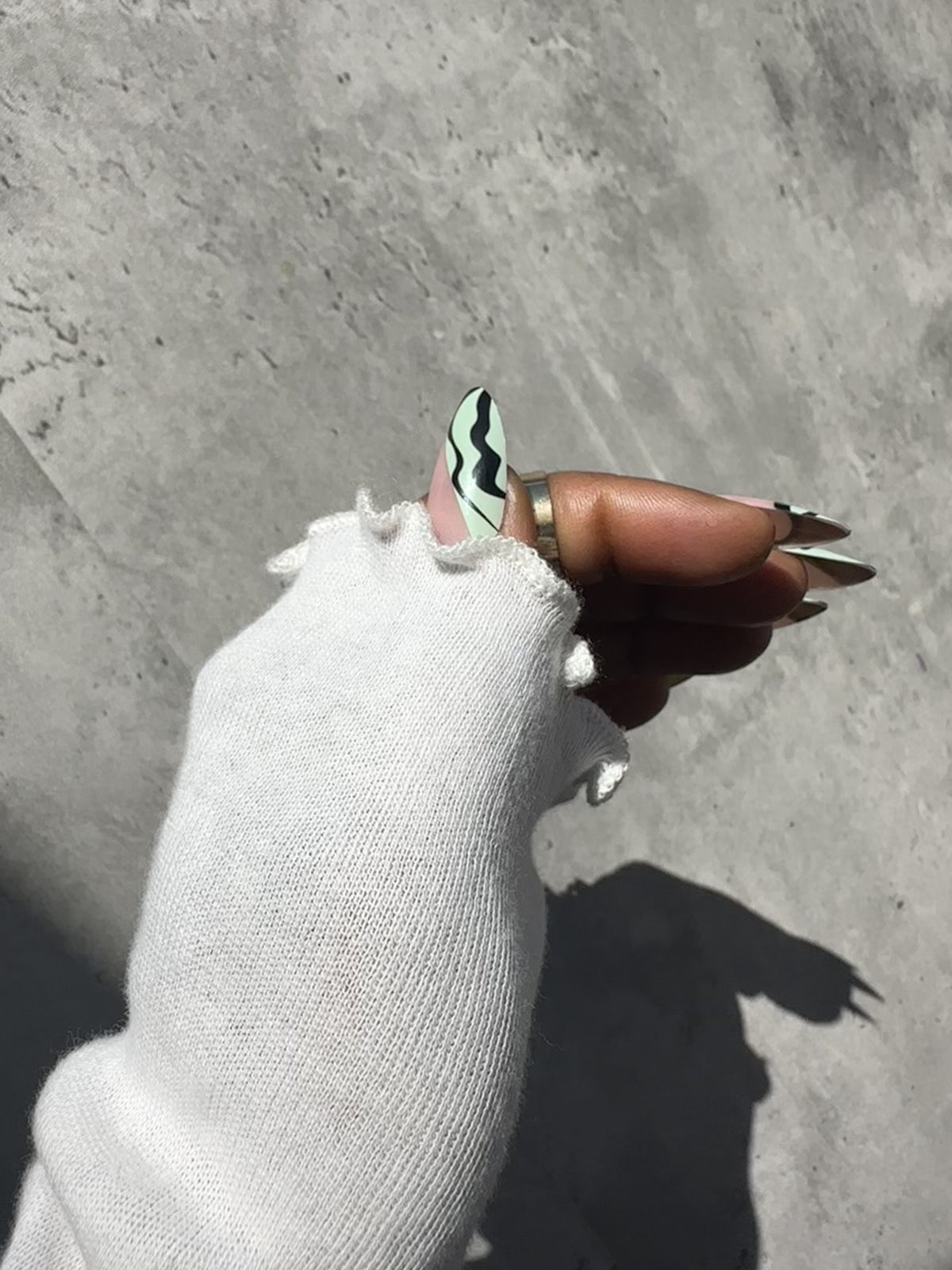 Thumb with Jade press-on nail, elegant and modern