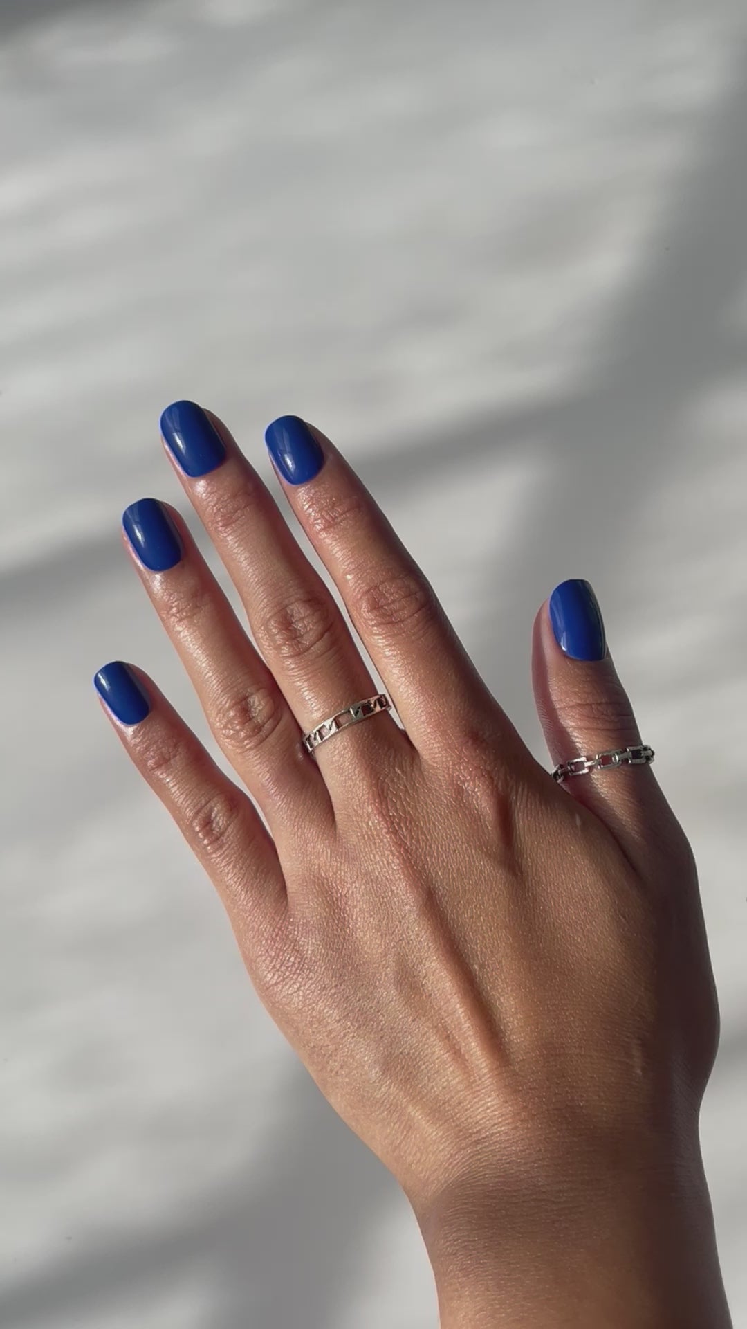Hand displaying indigo press-on nails
