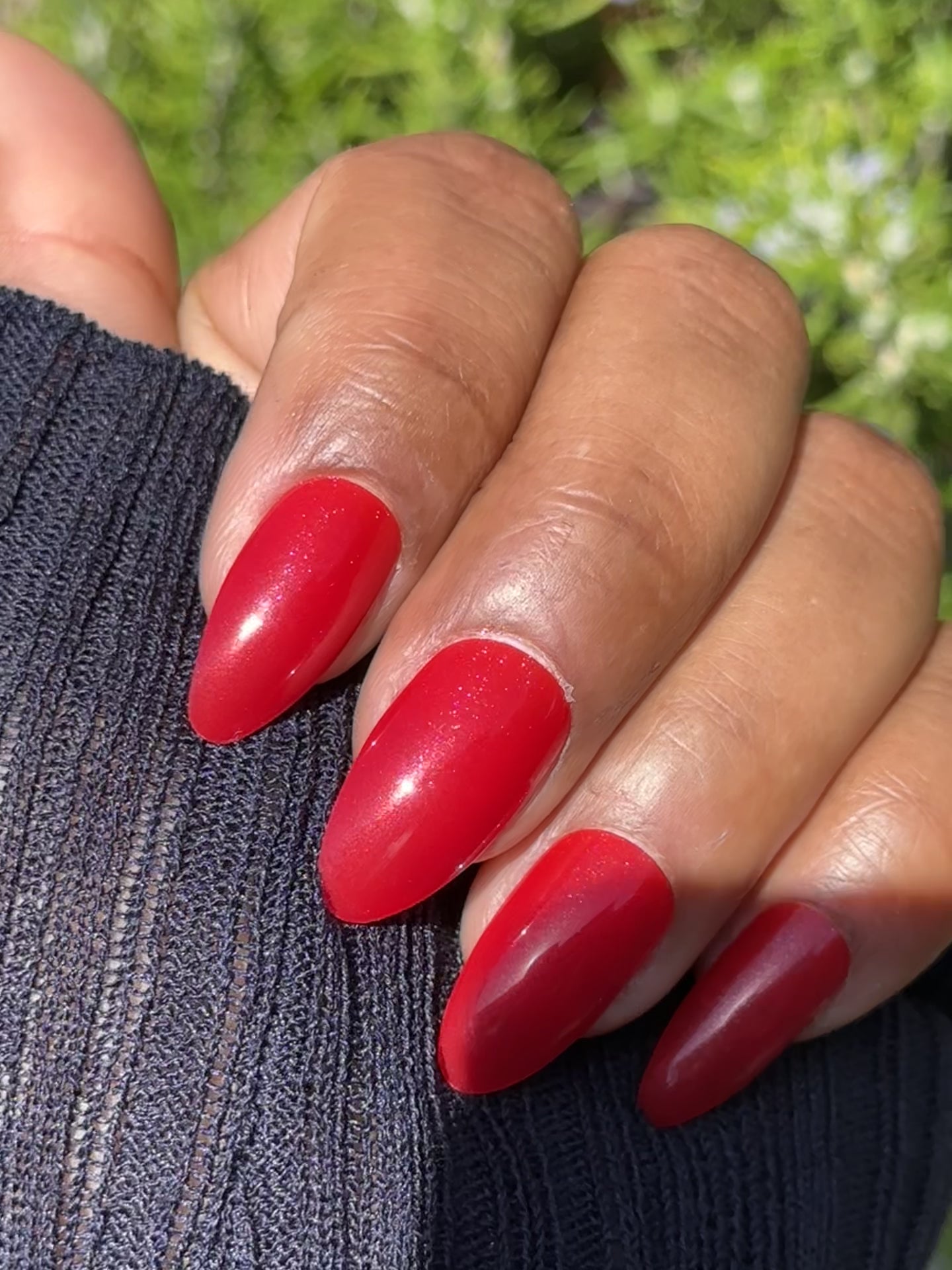 Close-up of shimmering red press-on nails