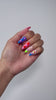 Multi-colored press-on nails for a fun summer look